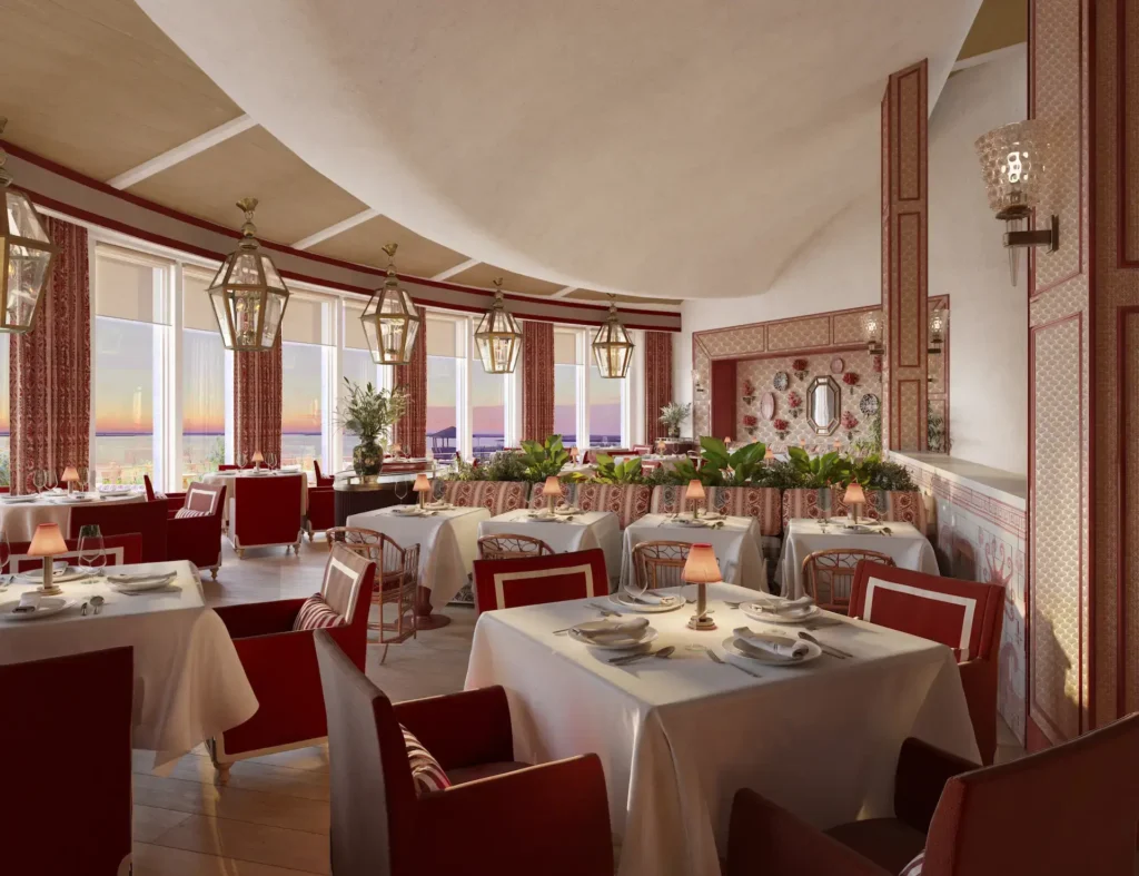 Restaurant at The Sanderling Resort with warm lights over the tables, decorated in burgundy tones combining patterns with solid colors.