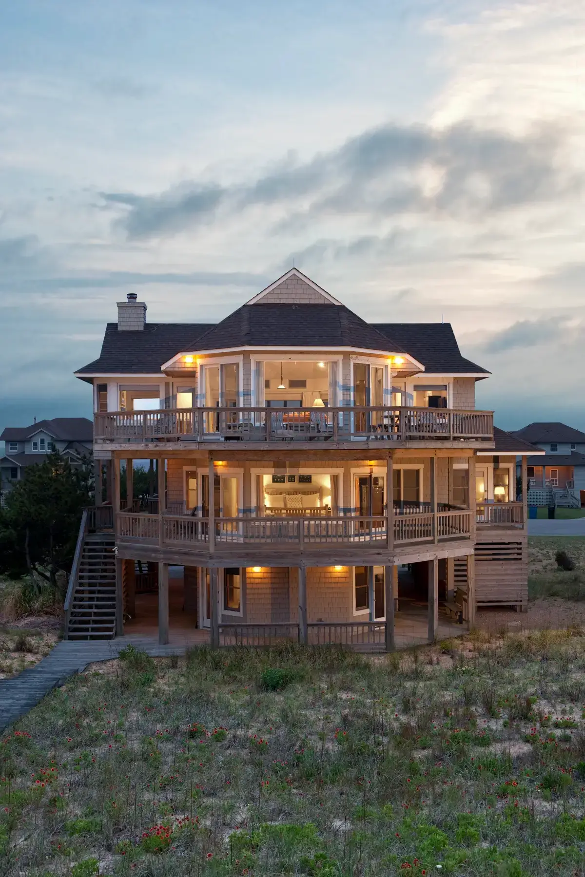 Front aerial view of Caffey House 6 Bedroom Residence at sunset.